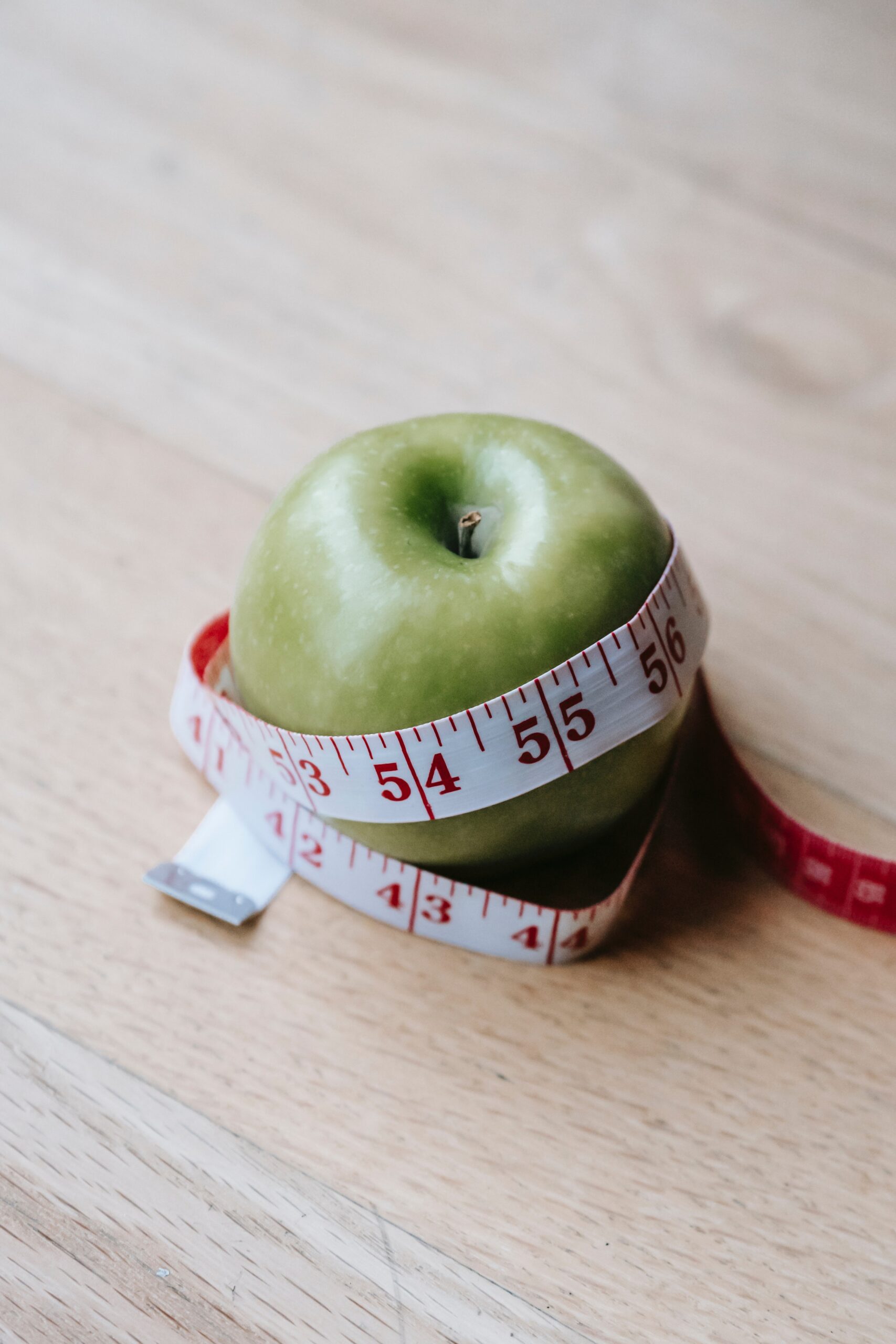 Pomme verte avec un ruban à mesurer autour pour mesurer les calories